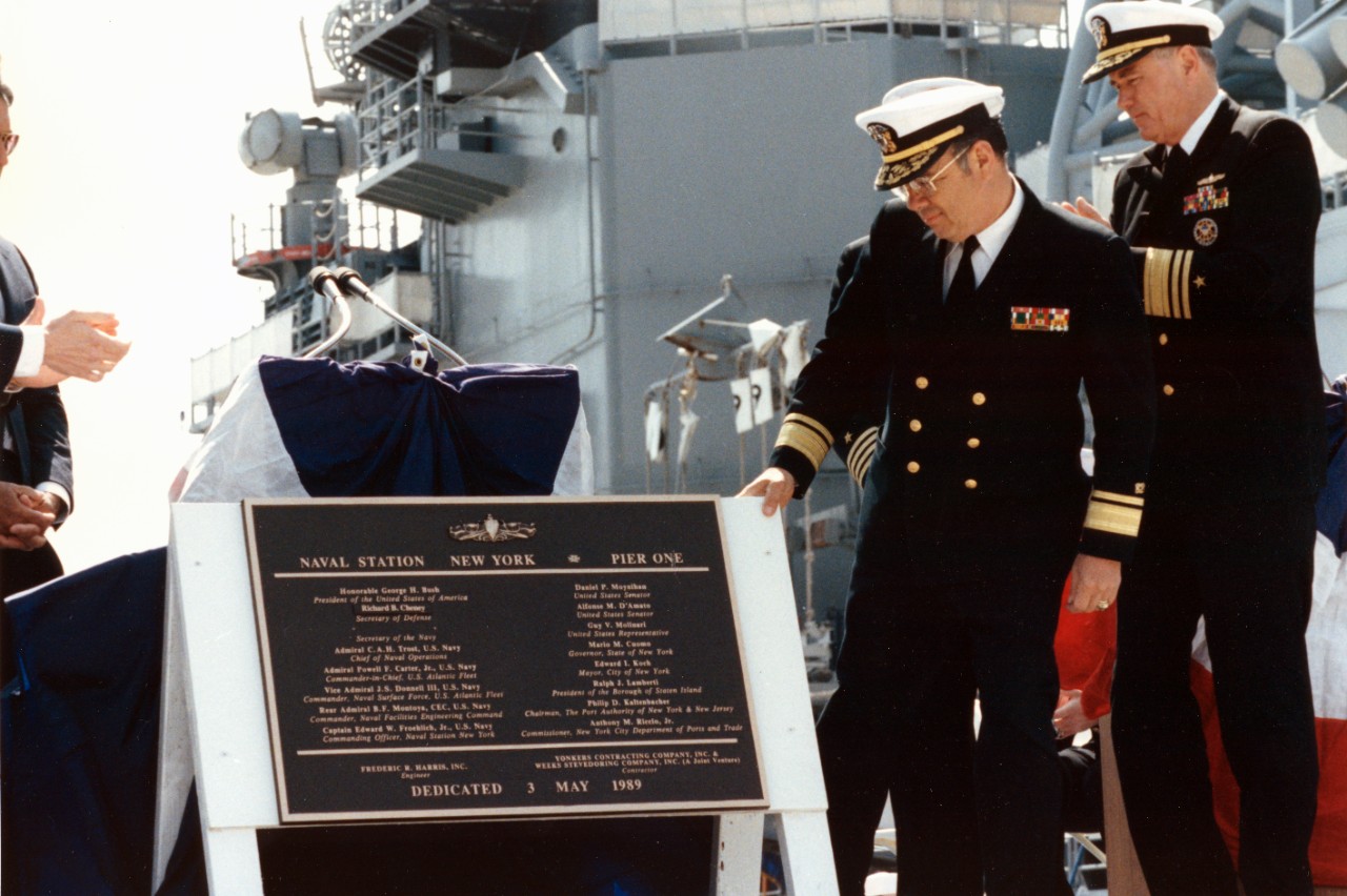 Rear Admiral Benjamin Montoya, commander, Naval Facilities Engineering Command, and Vice Admiral Joseph S. Donnell III, commander, Naval Surface Fleet, Atlantic, admire the plaque commemorating the dedication of the newly constructed Pier 1 during the pier's dedication ceremony, part of Navy Fleet Week activities in New York.