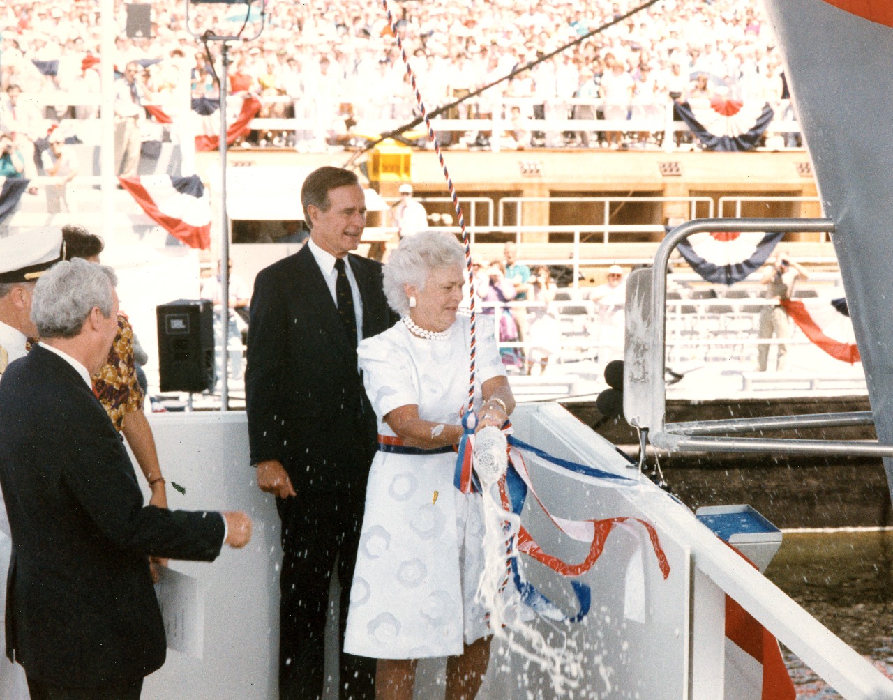 Newport News, VA - President George H.W. Bush stands by as Barbara Bush, ship's sponsor, christens the nuclear-powered aircraft carrier USS George Wasington (CVN-73). Edward J. Campbell, president of Newport News Shipbuilding, is at left. July 21, 1990. 