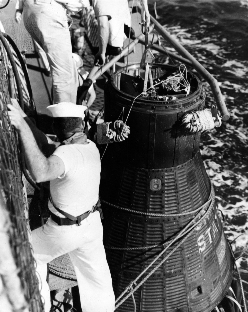 Cape Canaveral, FL - astronaut John H. Glenn's spacecraft, Friendship 7, being brought alongside recovery ship USS Noa (DD-841) after world orbital flight, February 20, 1962