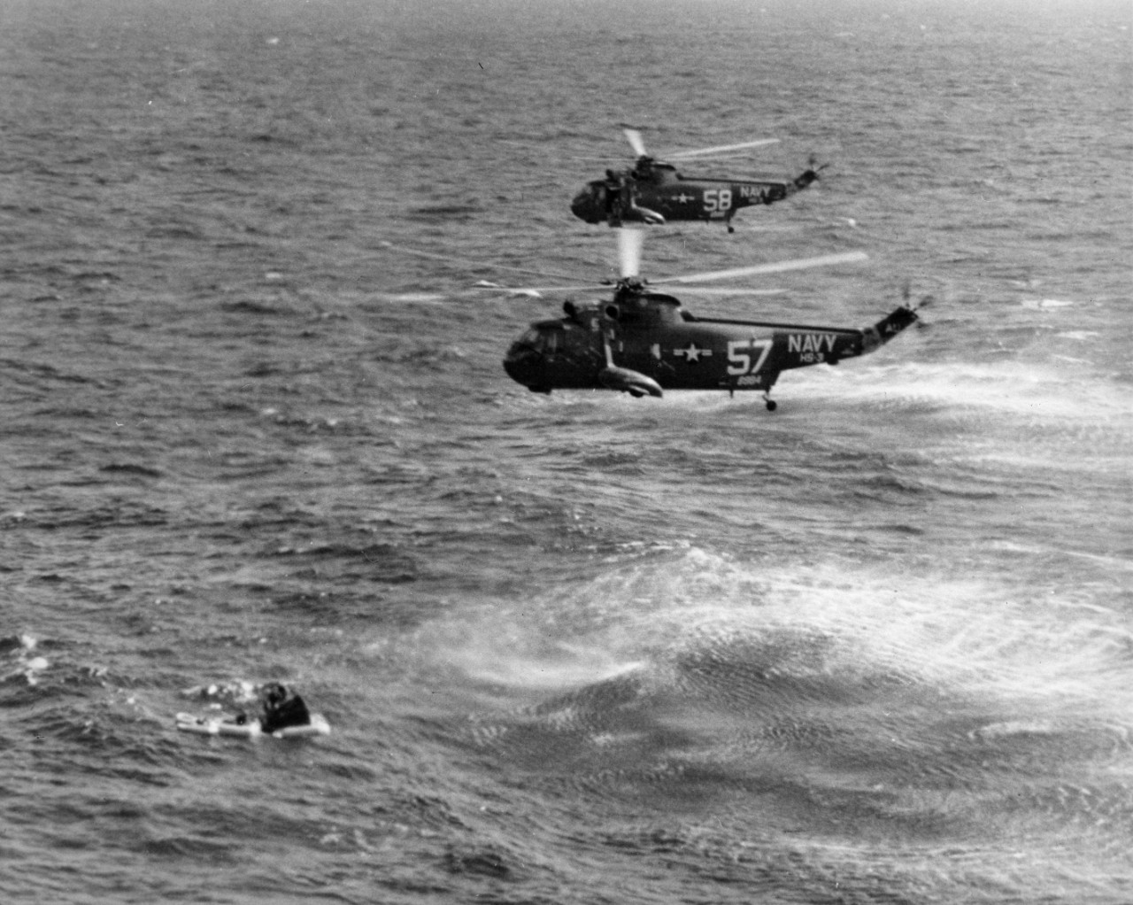 Helicopters of squadron HS-3 hover over the Gemini 3 spacecraft.