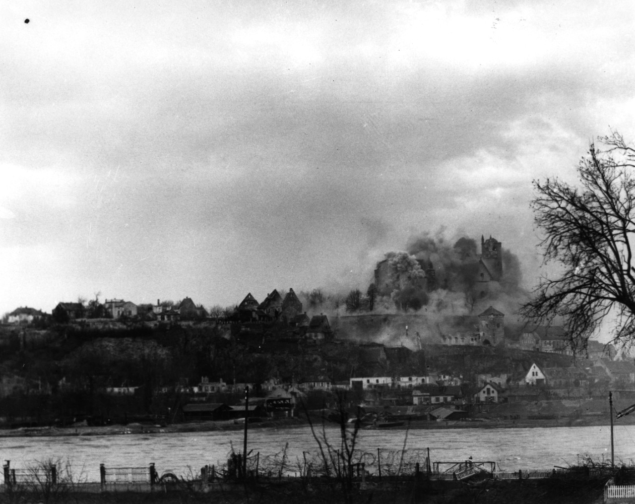 US Army 155mm howitzers hit a German observation post as US forces prepare to cross the Rhine River at Neuf Breisach, France, 13 February 1945. Town on the German side is probably Breisach.