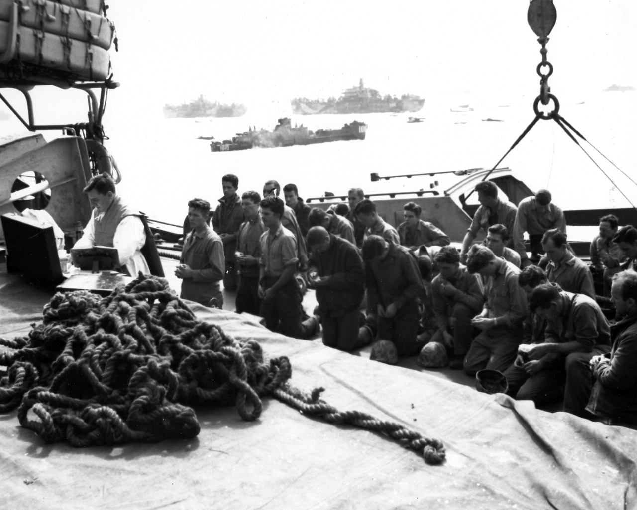 <p>Men of the floating reserve regiment (4th Marine Division) attend a Catholic mass before their time in hell.</p>
