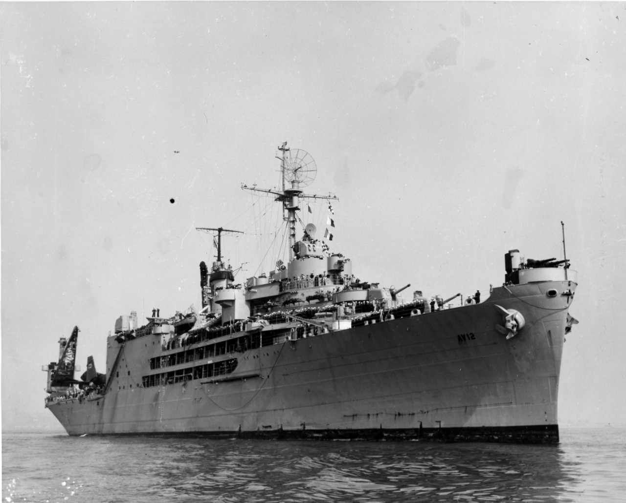 <p>Starboard bow&nbsp;view of USS&nbsp;<i>Pine Island</i>&nbsp;(AV-12) with sailors manning the rails, circa 1945-1950.</p>