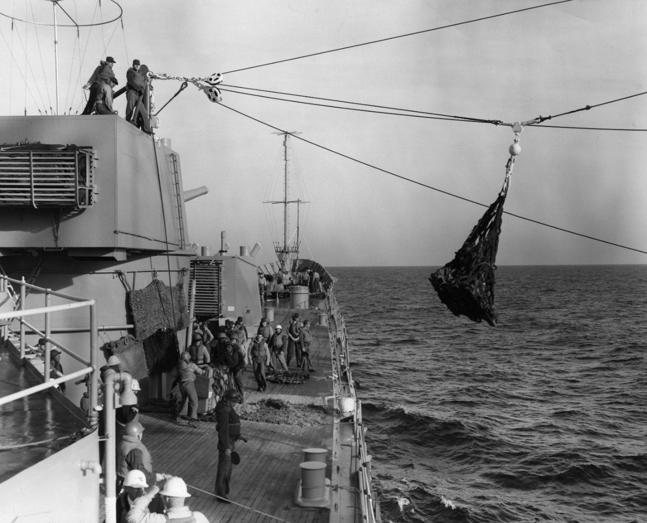 Stores are passed by highline to USS Boston (CAG-1) during underway replenishment.