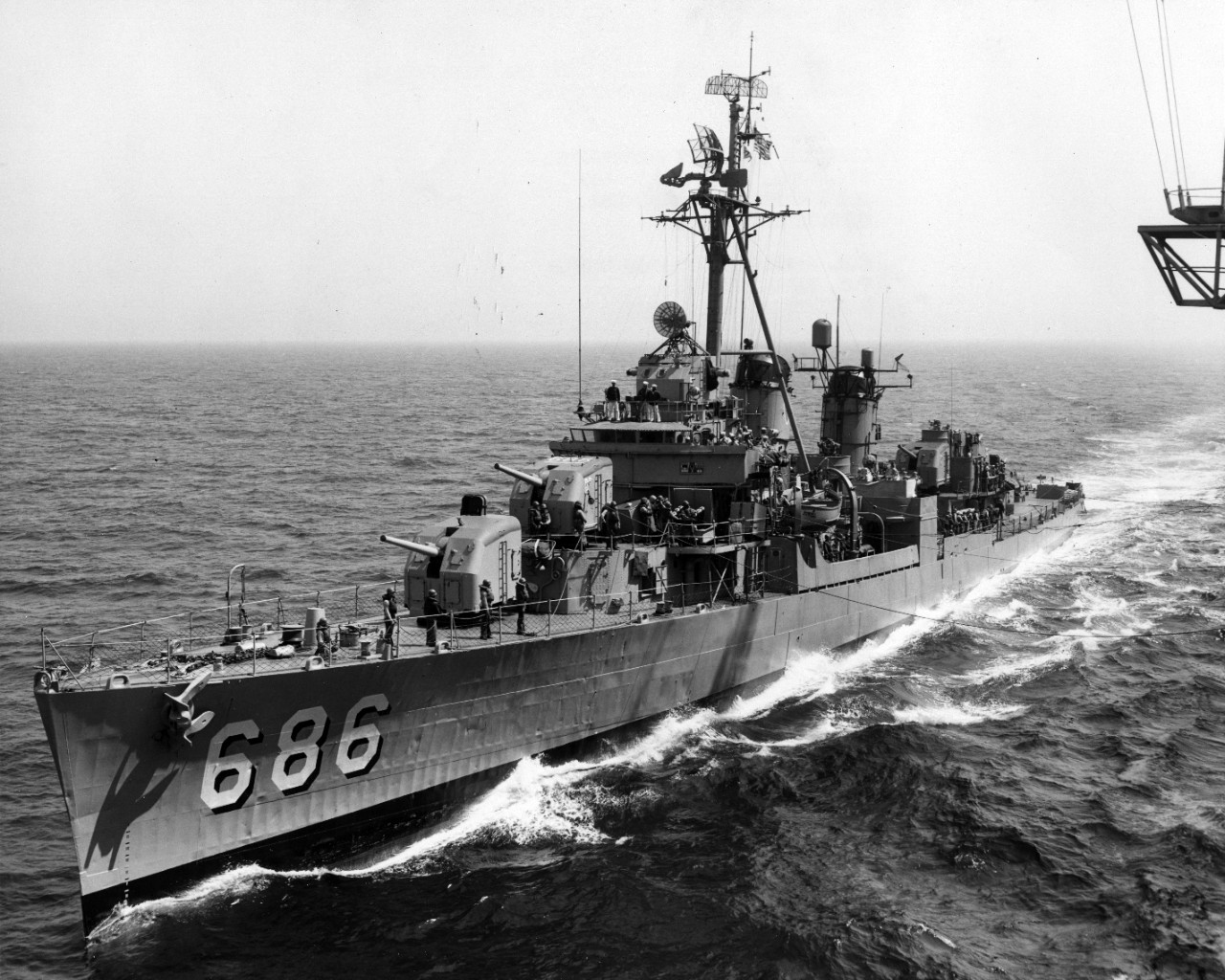 USS Halsey Powell (DD-686) alongside USS Ticonderoga (CVA-14) for high line transfer.