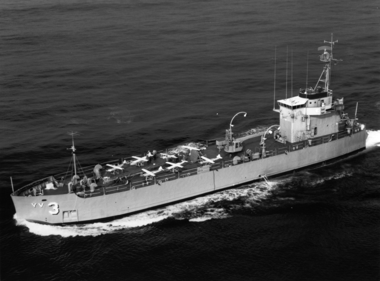 Aerial view of drone aircraft catapult control ship USS Targeteer (YV-3) underway off the coast of California. Note drone aircraft on deck.