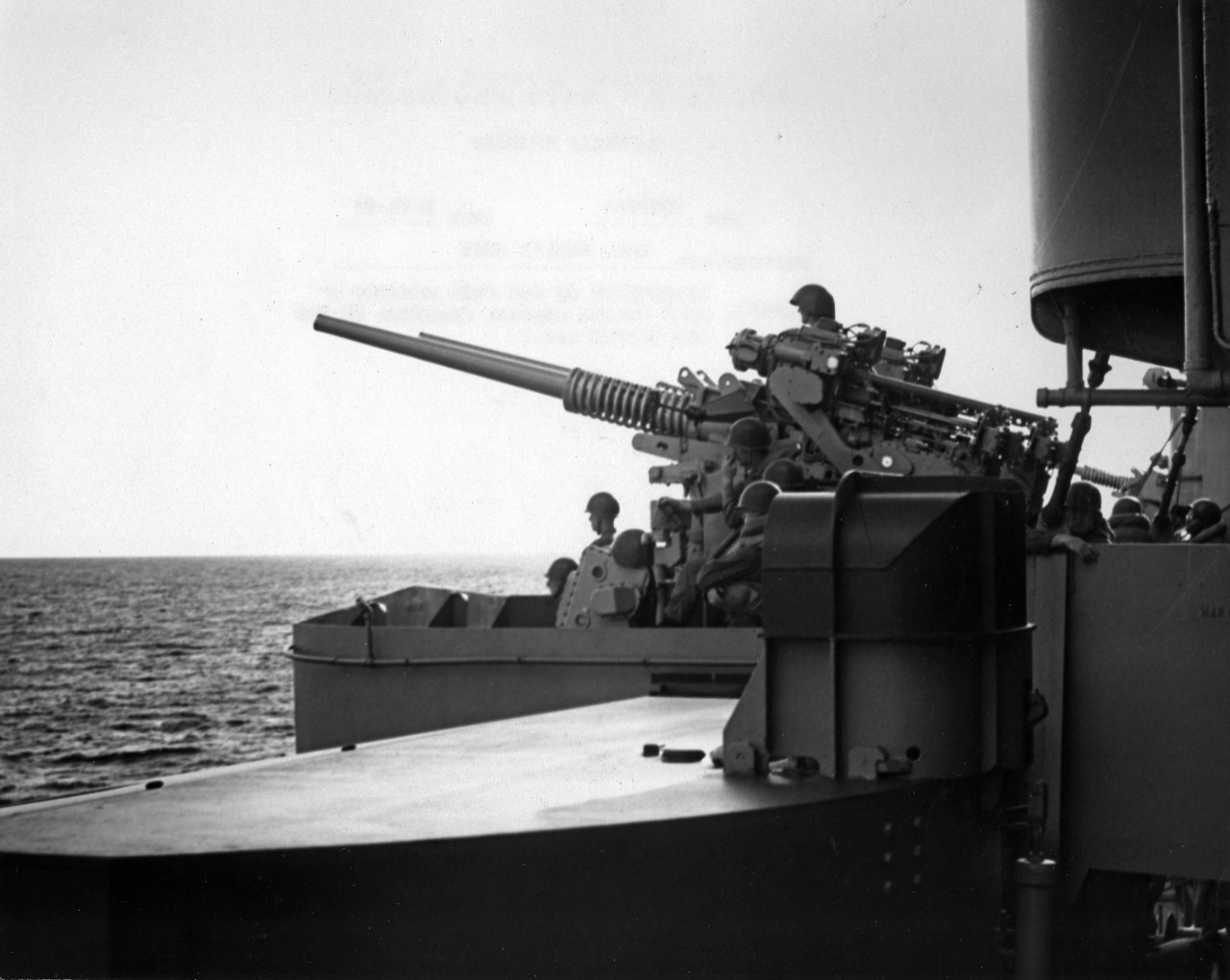 Gun crew manning 3" guns during general quarters on board USS Boston (CAG-1) 