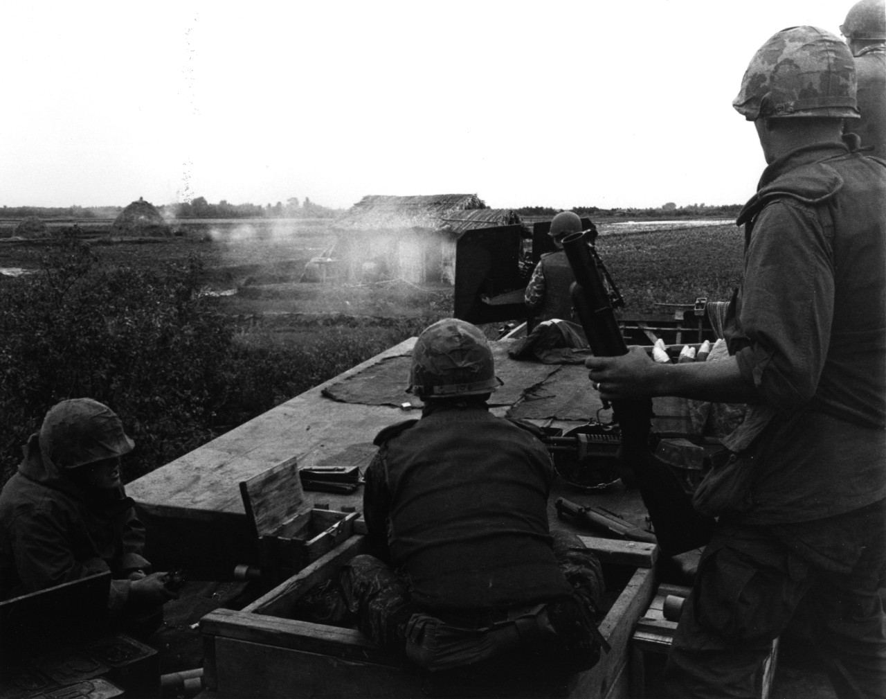 Members of a U.S. Navy SEAL Team aboard a mechanized landing craft fire on Viet Cong huts during a special Vietnamese-American operation in the Rung Sat Special Zone, Friday, 20 January 1967, approximately 15 miles south-southeast of Saigon.