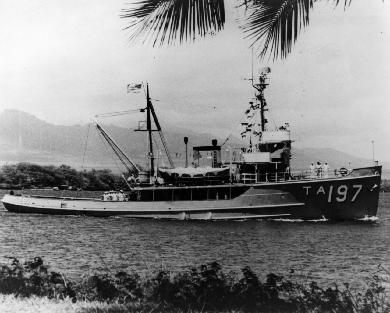 Tug USS Sunnadin (ATA-197) underway at Pearl Harbor, Hawaii, with her crew manning the rails