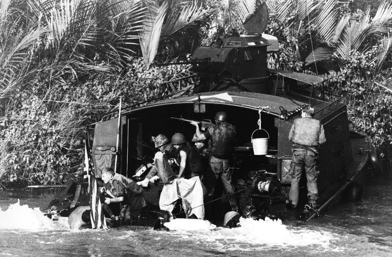 An Assault Support Patrol Boat (ASPB) is damaged by North Vietnamese action in the Mekong Delta area. The crew returns fire while attempts are made to plug up the holes and keep the boat afloat.