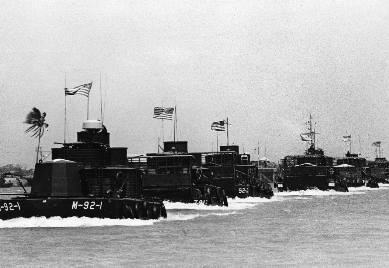 A monitor leads a formation of River Division 92 Armored Troop Carriers (ATC) on a canal in the Mekong River Delta area.