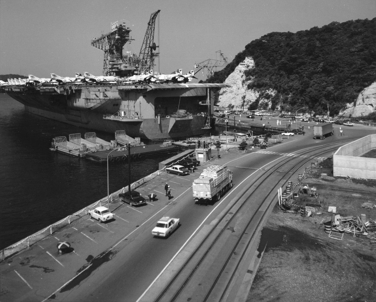 USS America (CVA-66) moored beside a pier at Yokusuka, Japan.