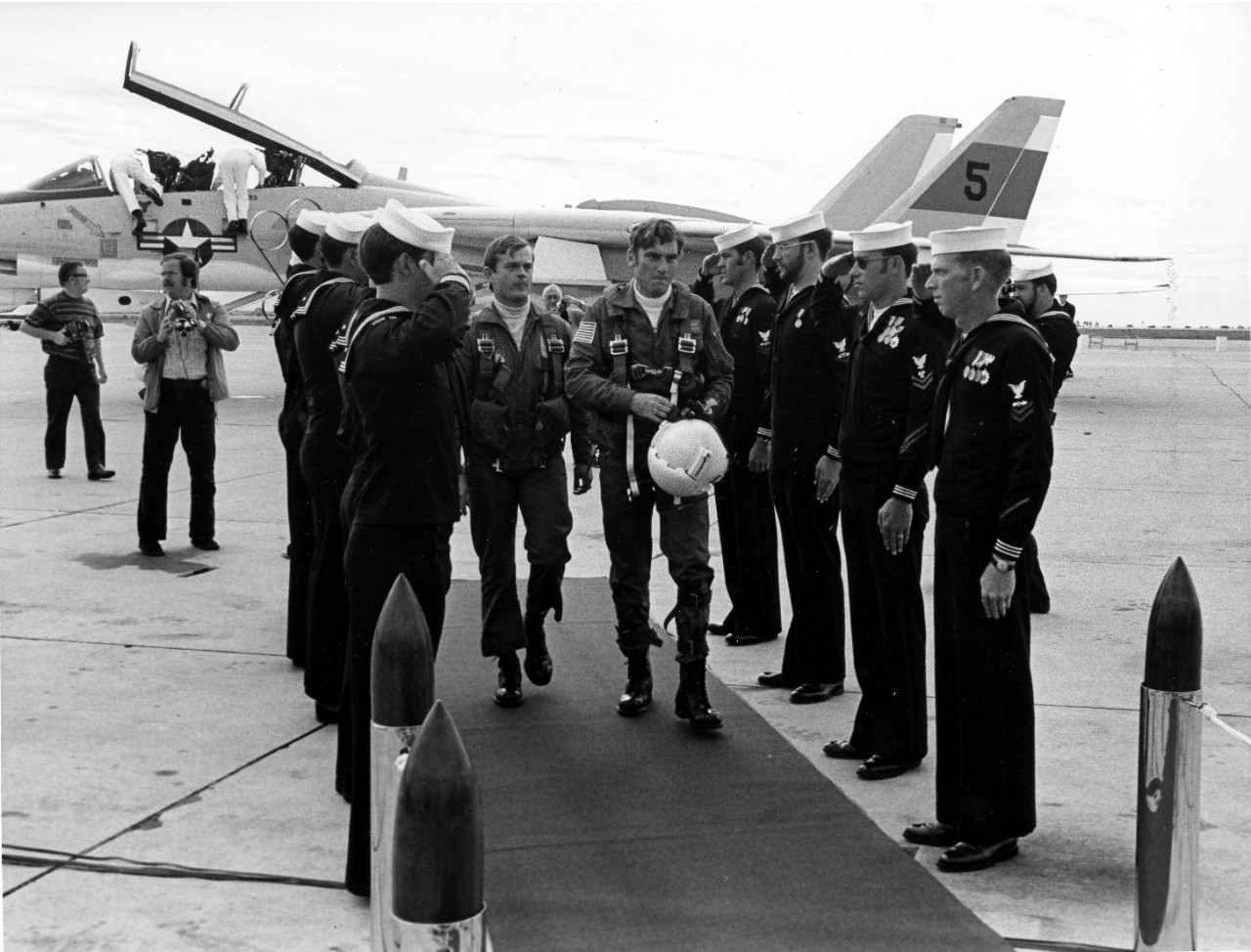 <p>Naval Air Station Miramar, CA - the Honorable John W. Warner, Secretary of the Navy, walks between the sideboys as he arrives at the station for the establishment ceremony for fighter squadrons one and two (VF-1 and VF-2). He arrived in an F-14A Tomcat fighter aircraft which is what the two squadrons will be flying. October 14, 1972.</p>
