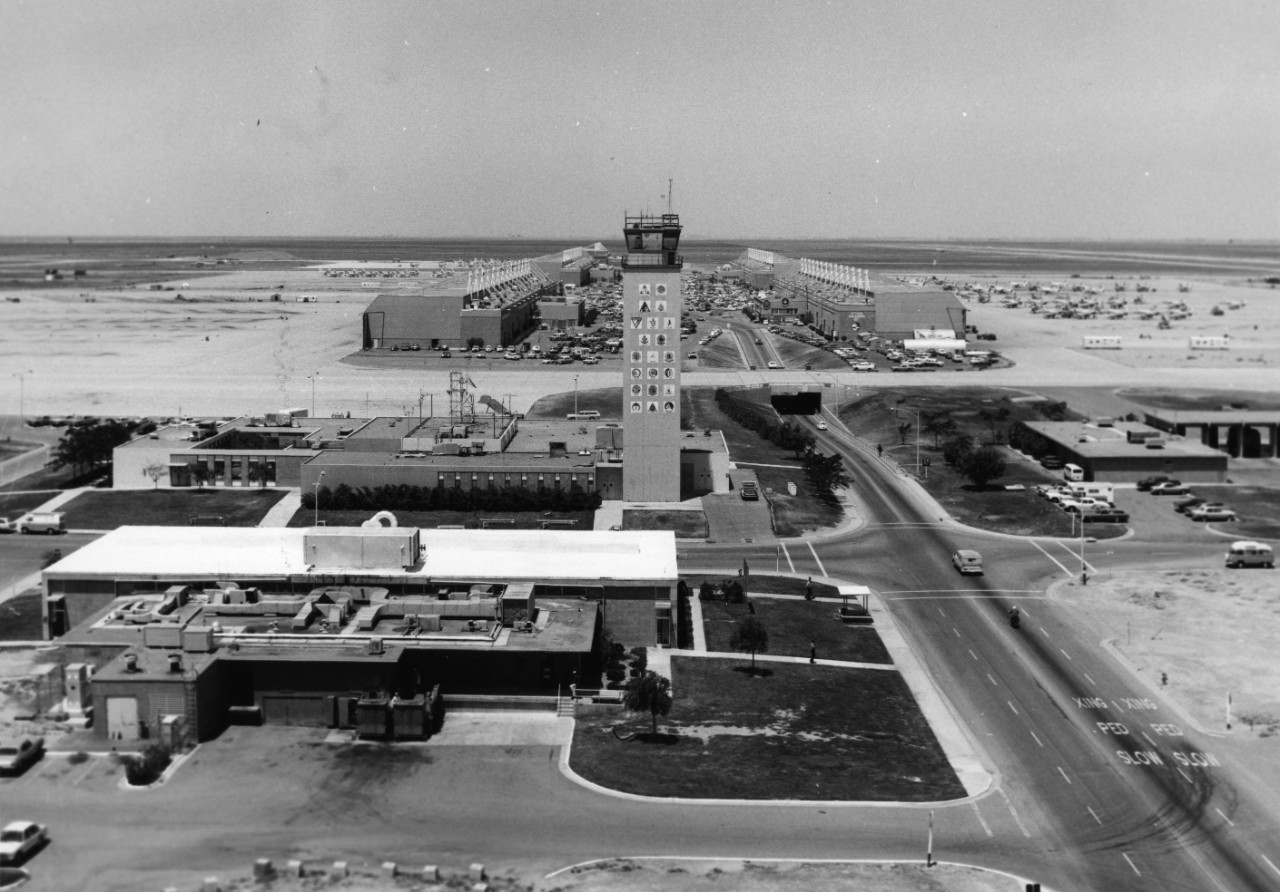 Aerial view of the control tower at Naval Air Station Lemoore, with hangars and aircraft in the background