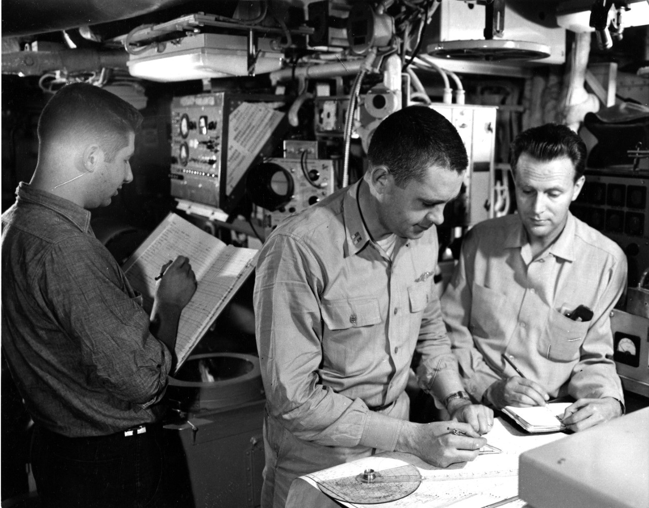 Checking position of USS Nautilus (SSN-571) from internal navigation system during final approach to the North Pole. August 12, 1958. Image is from the USS Nautilus Collection, UA 475.05