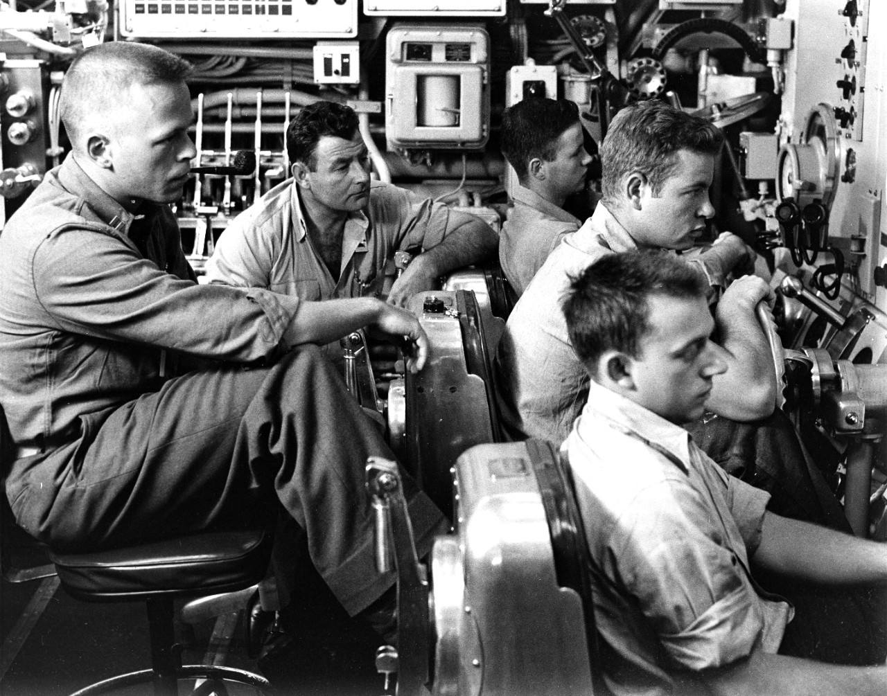 <p>The watch crew in the control room of the USS Nautilus maintain exact course and depth while the ship is passing under the polar ice cap. August, 1958. Image is from the USS Nautilus Photo Collection, UA 475.05.</p>
