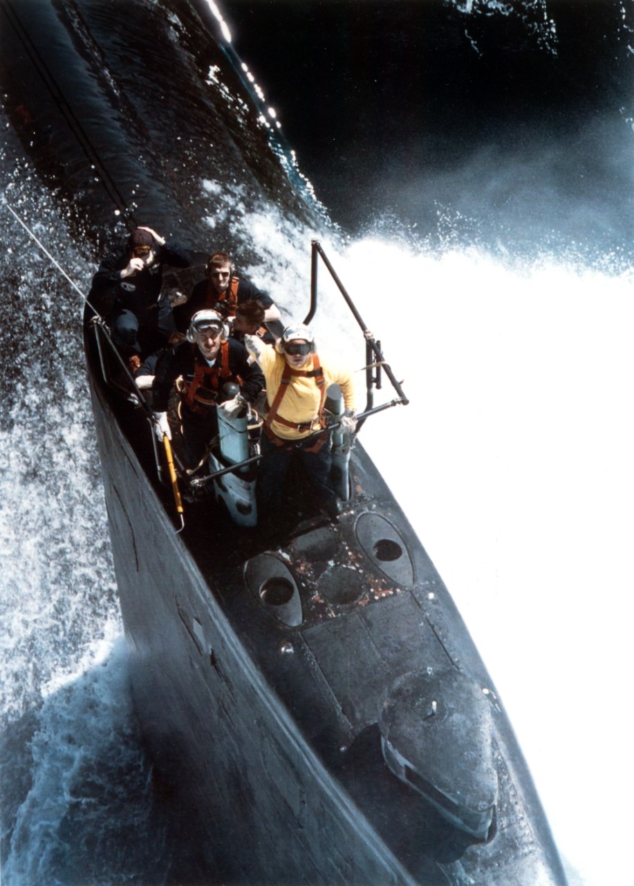 Sailors stand by on the sail of Los Angeles class submarine USS Scranton (SSN-756) for a supply delivery from an SH-60F "Seahawk" helicopter while surfaced in the Arabian Sea. The Seahawk was from the "Nightdippers" of Anti-Submarine Squadron Five, and was flying from the flight deck of aircraft carrier USS George Washington (CVN-73).