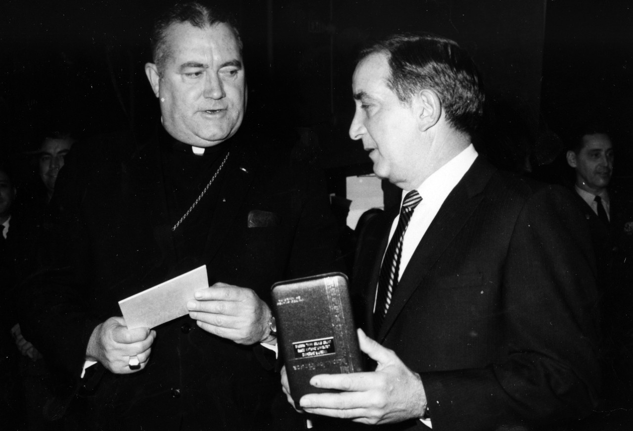 Bishop William J. Moran, D.D., Auxiliary Bishop, Military Ordinariate, chats with Mr. James S. Capodanno of Staten Island, New York, who holds the Medal of Honor was that awarded posthumously to his brother, Lieutenant Vincent R. Capodanno, a Navy Chaplain. The Medal was presented to Mr. Cappodanno by Secretary of the Navy Paul R. Ignatius in a ceremony held at the Washington Navy Yard, Washington DC, on Tuesday, January 7, 1969.