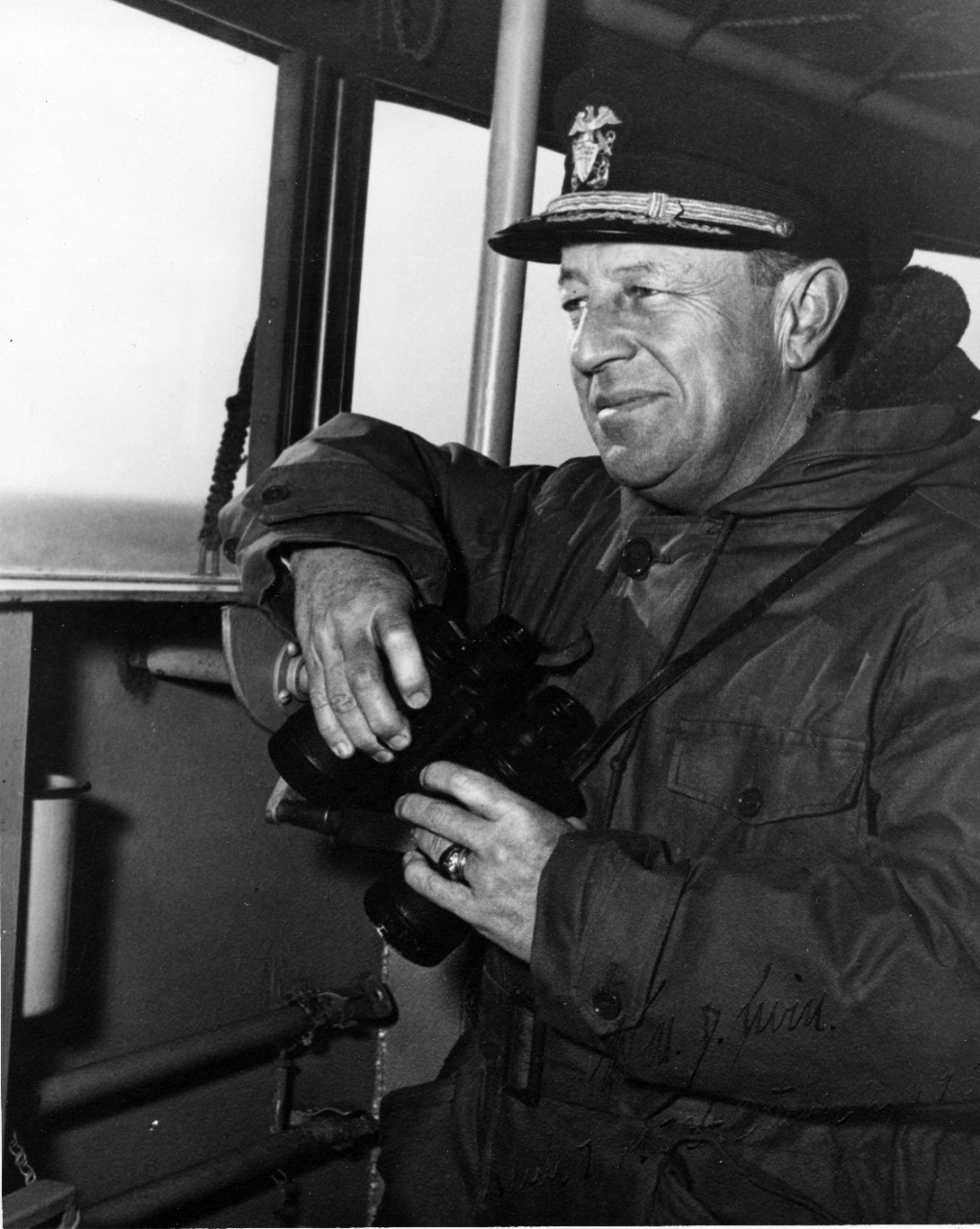 RADM William D. Irvin with binoculars aboard an unknown ship. No date. 