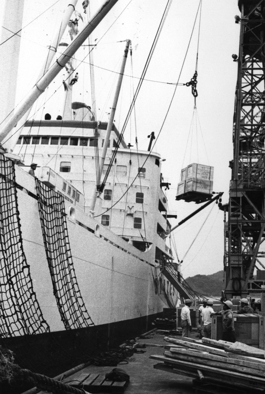 A merchant ship unloads cargo at U.S. Fleet Activities, Yokosuka. The depot loads and unloads nearly 40 ships and handles approximately 70,000 tons of material each month.
