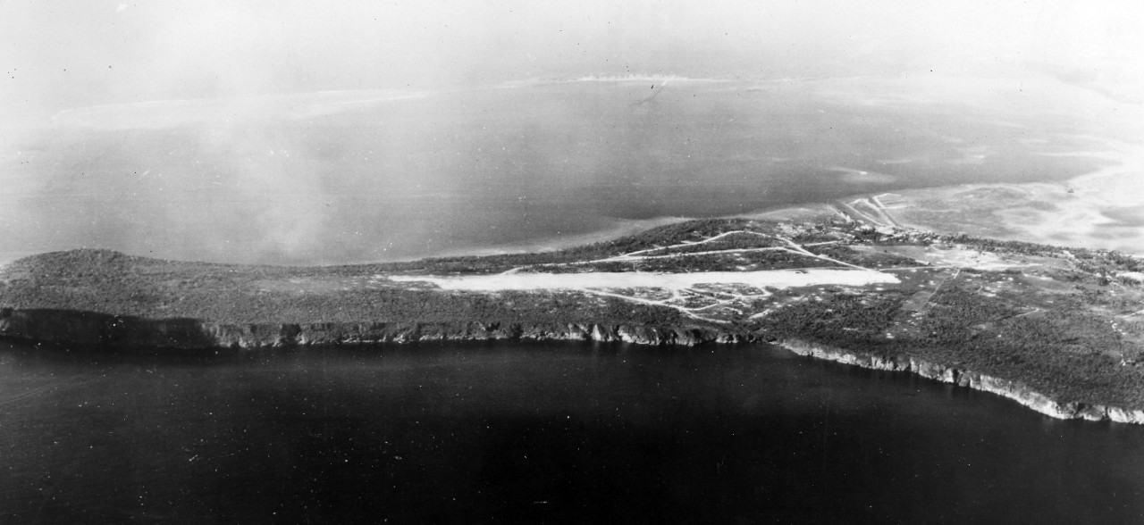 Captured airfield on Guam's Orote peninsula. Flanked on two sides by rocky western Pacific palisades, the Orote airfield was put in use shortly after then initial landings on Guam. American planes are new operating from the field in support of ground forces driving northward. August 2, 1944. 