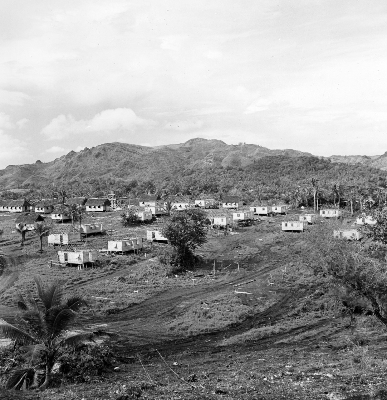 Guam "boom town" - their own homes wrecked in the destruction attendant upon the battle for Guam, many natives of the island now live in these homes built by the US Civil Affairs authorities. The settlement is known as Sinajana. March 20, 1945.