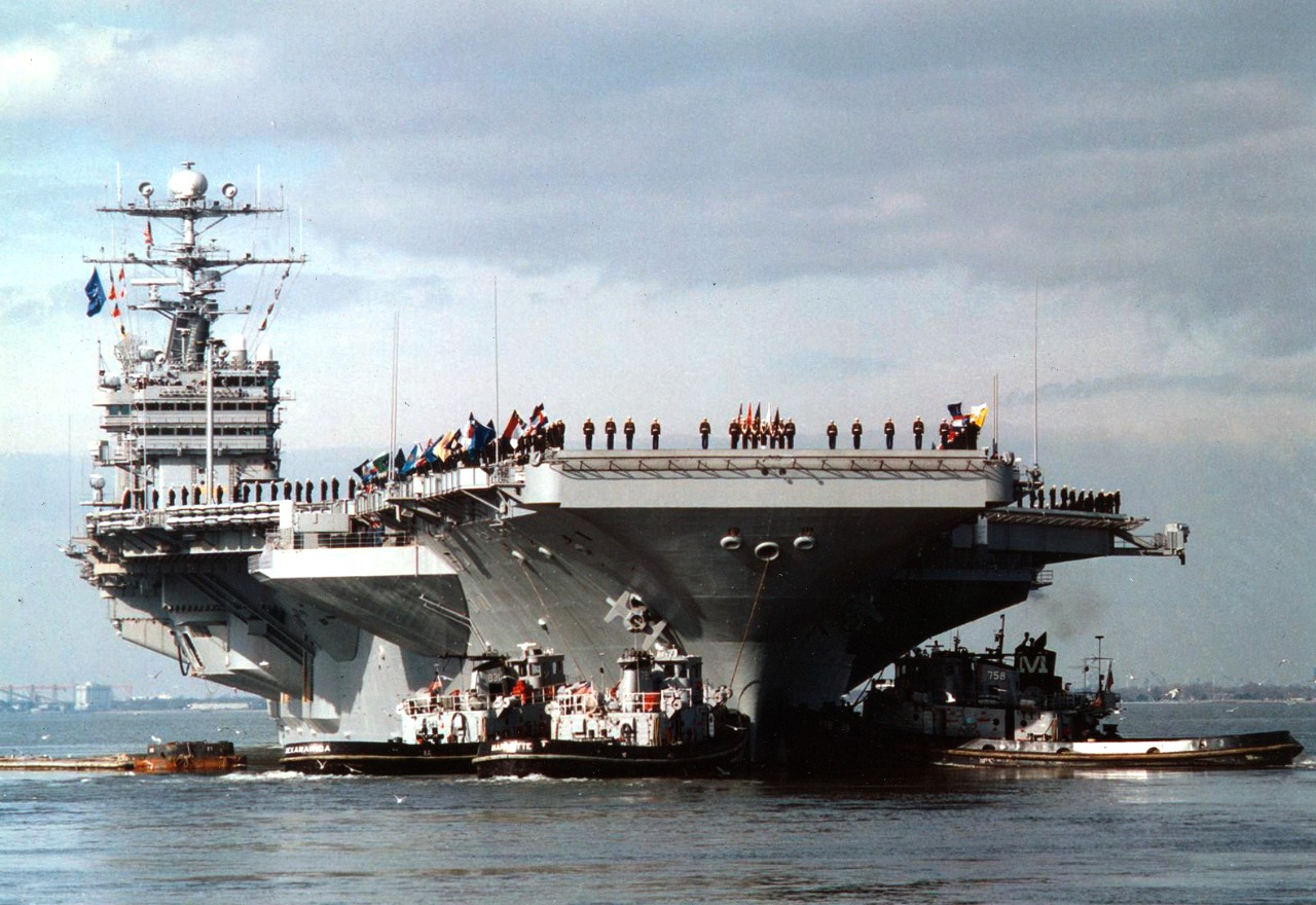 With her crew manning the rails, USS George Washington (CVN-73) heads out to sea on January 26, 1996, a the commencement of a scheduled six-month deployment to the Mediterranean. USS George Washington will be operating in the Adriatic Sea in support of the NATO peace keeping Operation Joint Endeavor. 
