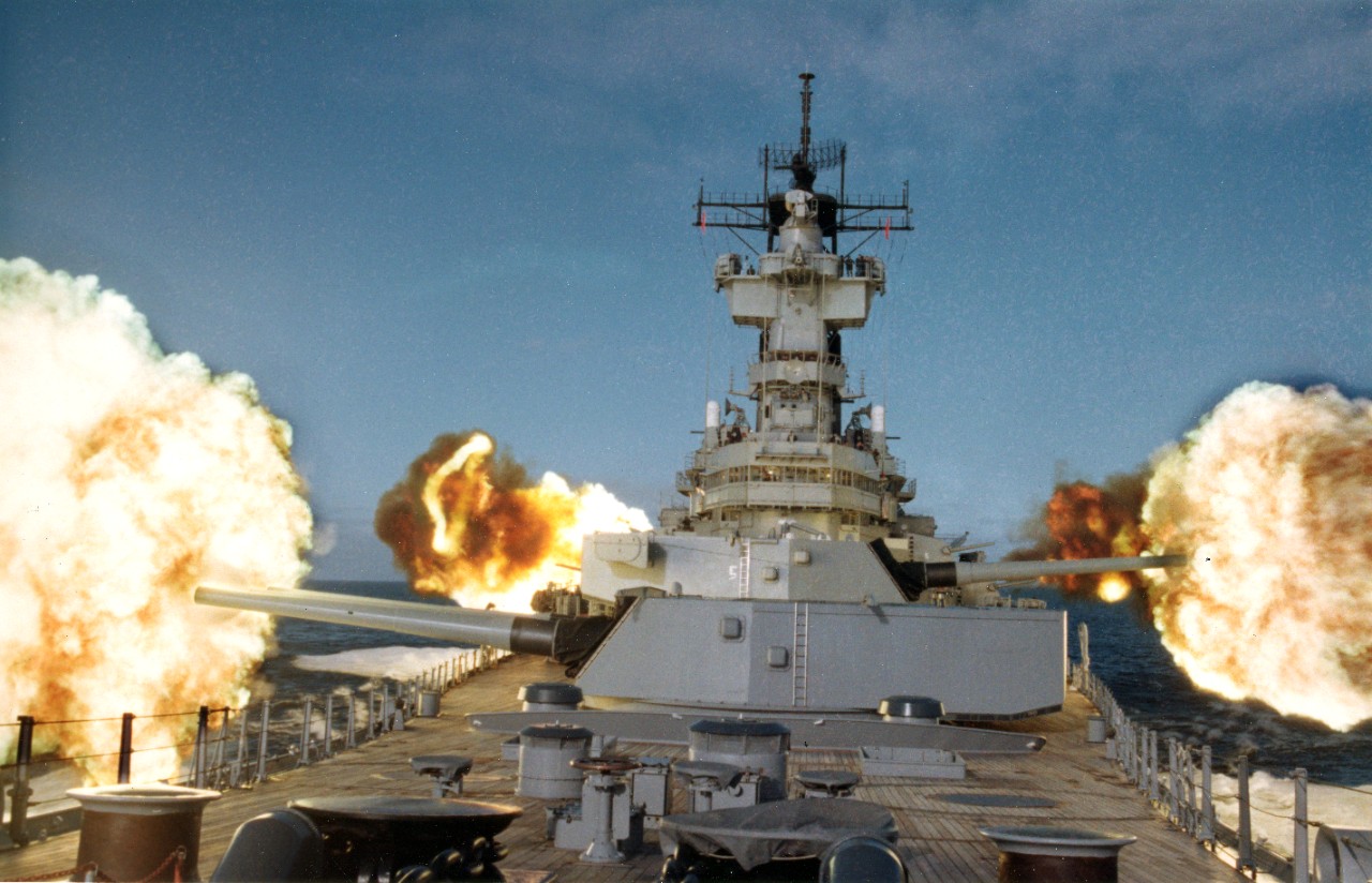 USS New Jersey (BB-62) fires her main 16" 50 caliber and 5" 38 caliber secondary guns, in the northern Pacific Ocean.