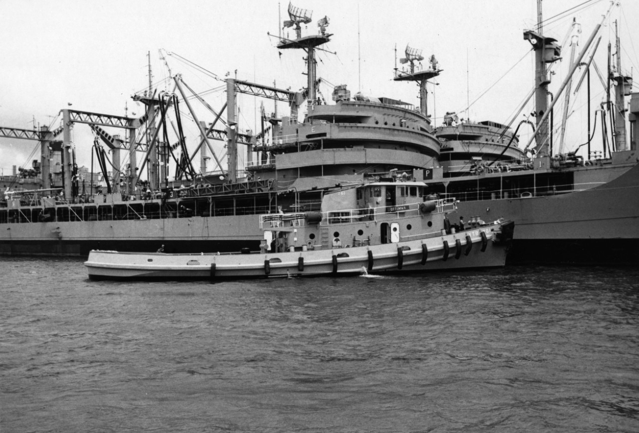 Harbor Tug Ottumwa (YTB-761) pushes Pearl Harbor-based USS Ponchatoula (AO-148) alongside its berthing pier.