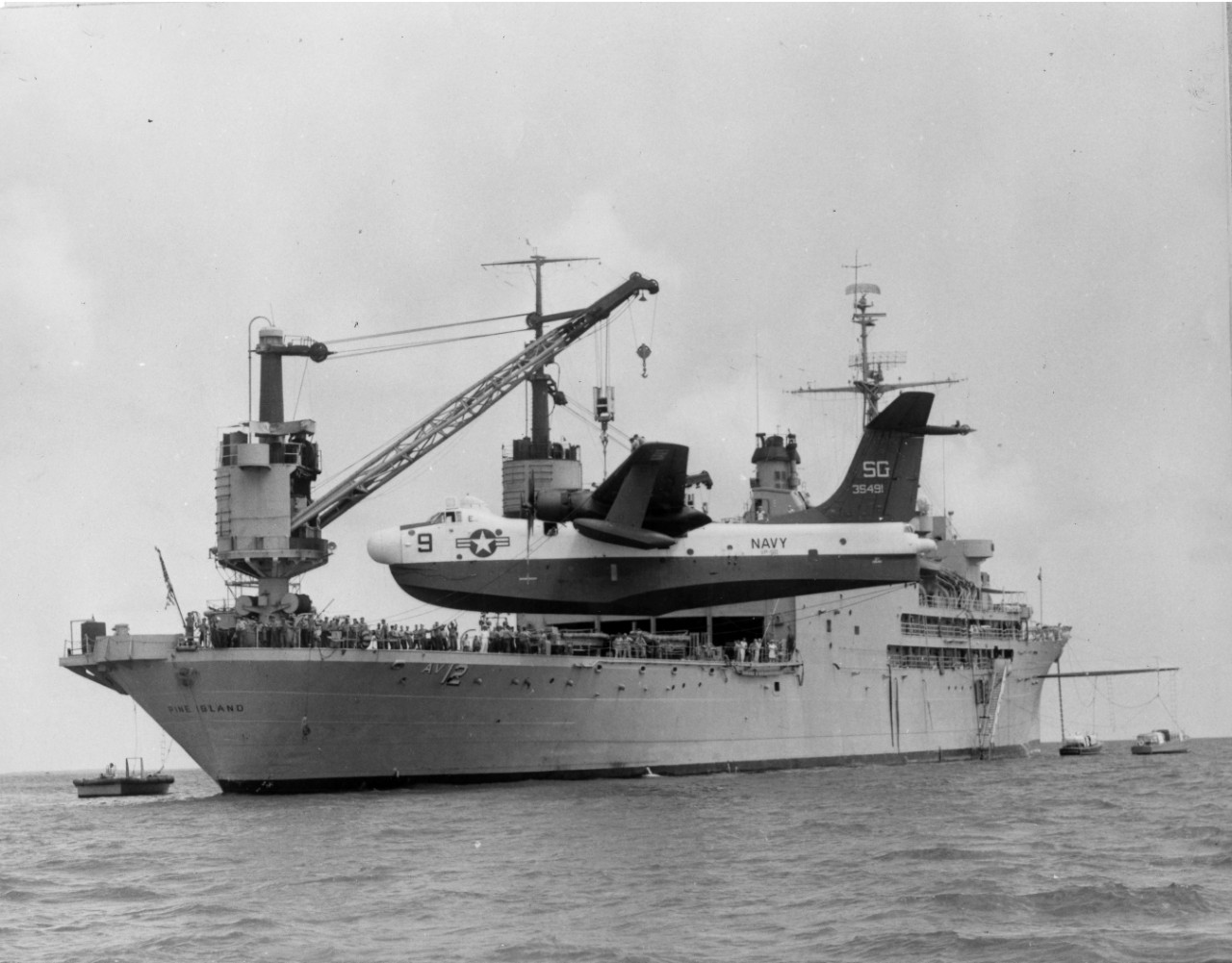 <p>Aircraft being off-loaded from USS&nbsp;<i>Pine Island</i>&nbsp;(AV-12) for a test flight prior to returning to duty. June 1961.</p>
