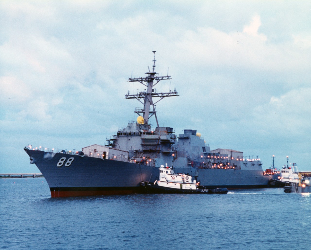 Future USS Preble (DDG-88), still under construction, is assisted by tugs