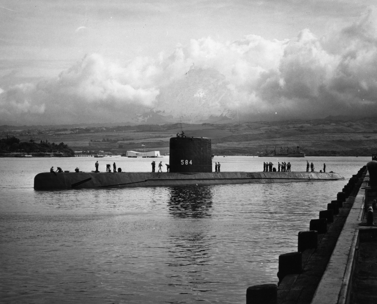 Nuclear powered attack submarine USS Seadragon (SSN-584) in Pearl Harbor Naval Shipyard, Oahu, Hawaii. In the background is Ford Island and the USS Arizona Memorial.