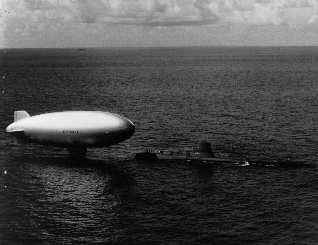 K-class blimp ZP2K-86 being taken under tow by submarine USS Sea Poacher (SS-406), circa 1952-1953