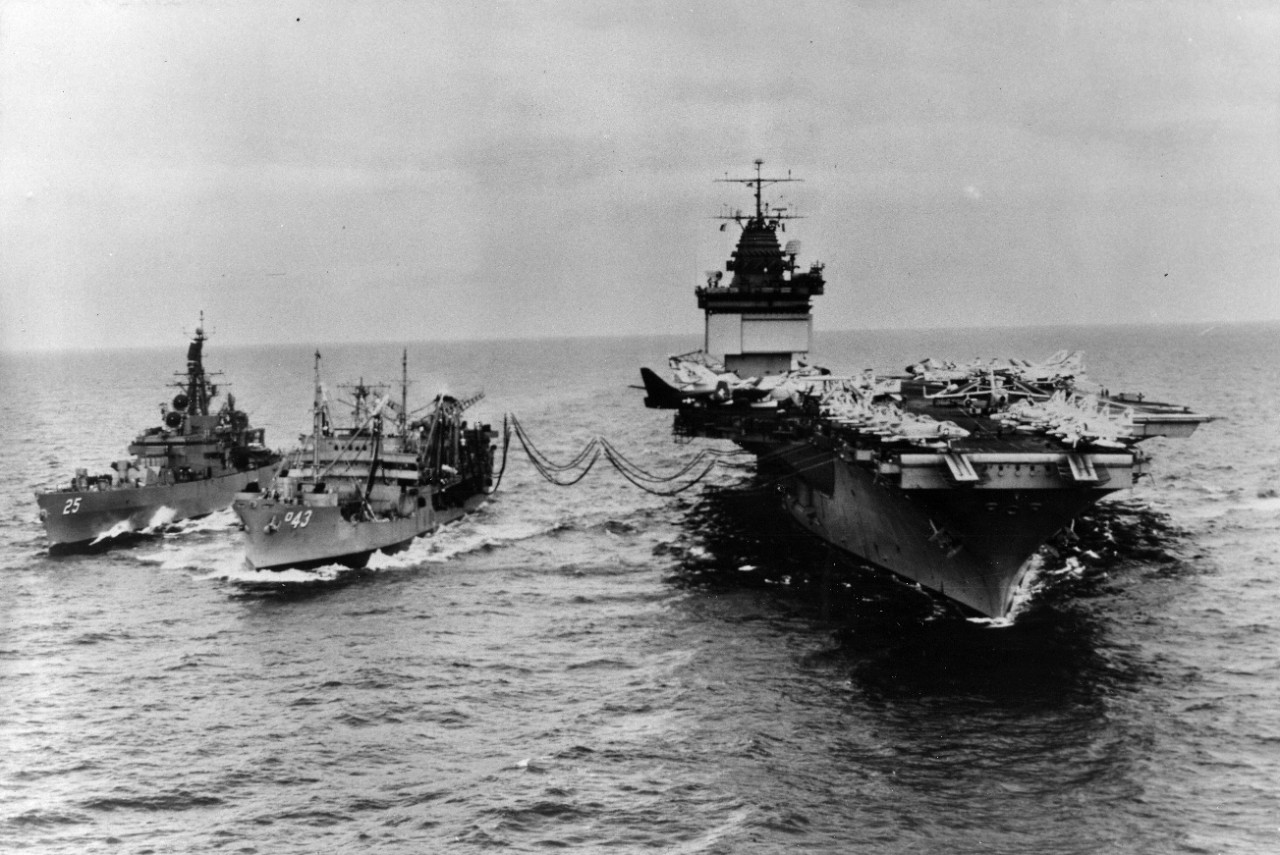 Fleet Oiler USS Tappahannock (AO-43) passes jet aircraft fuel to the nuclear powered aircraft carrier USS Enterprise (CVAN-65), while USS Bainbridge (CGN-25) comes alongside to starboard to receive mail.