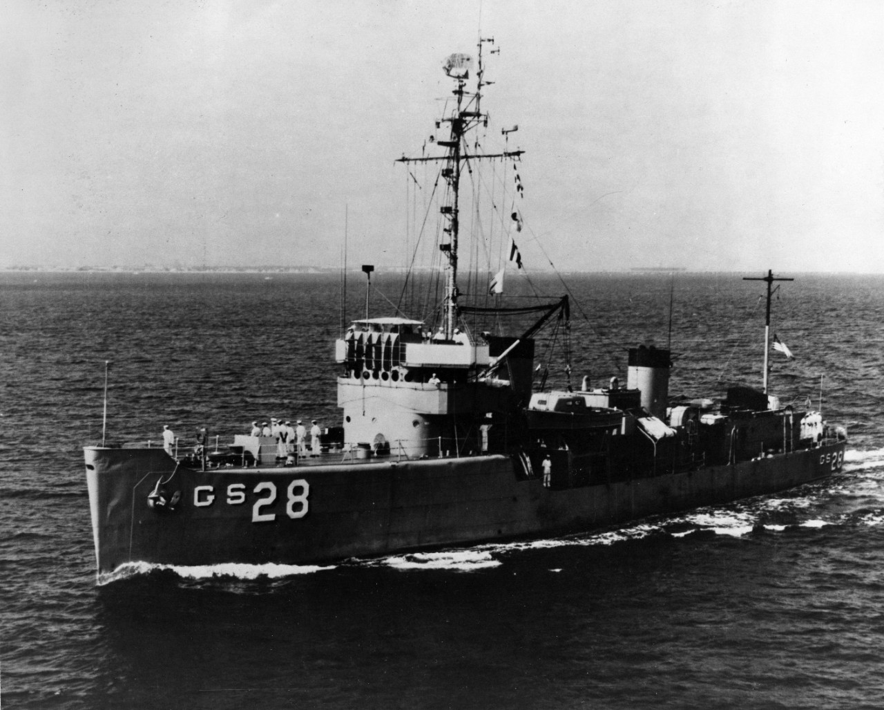 Port view of oceanographic survey ship USS Towhee (AGS-28) underway, with her crew manning the rails