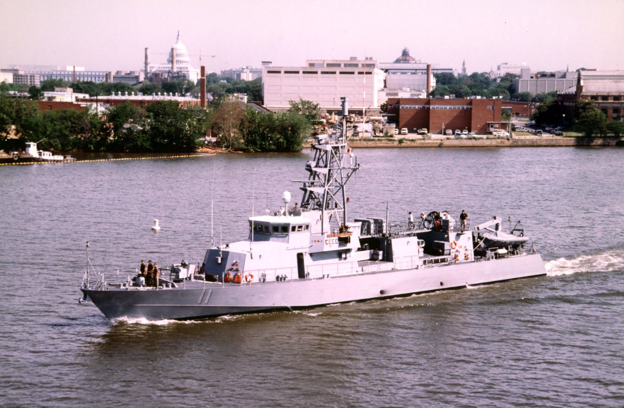 Port side view of coastal patrol craft USS Whirlwind (PC-11) approaching the Frederick Douglas Bridge as the ship departs the Washington Navy Yard after taking place in Armed Forces weekend. Note the U.S. Capitol dome in the background.