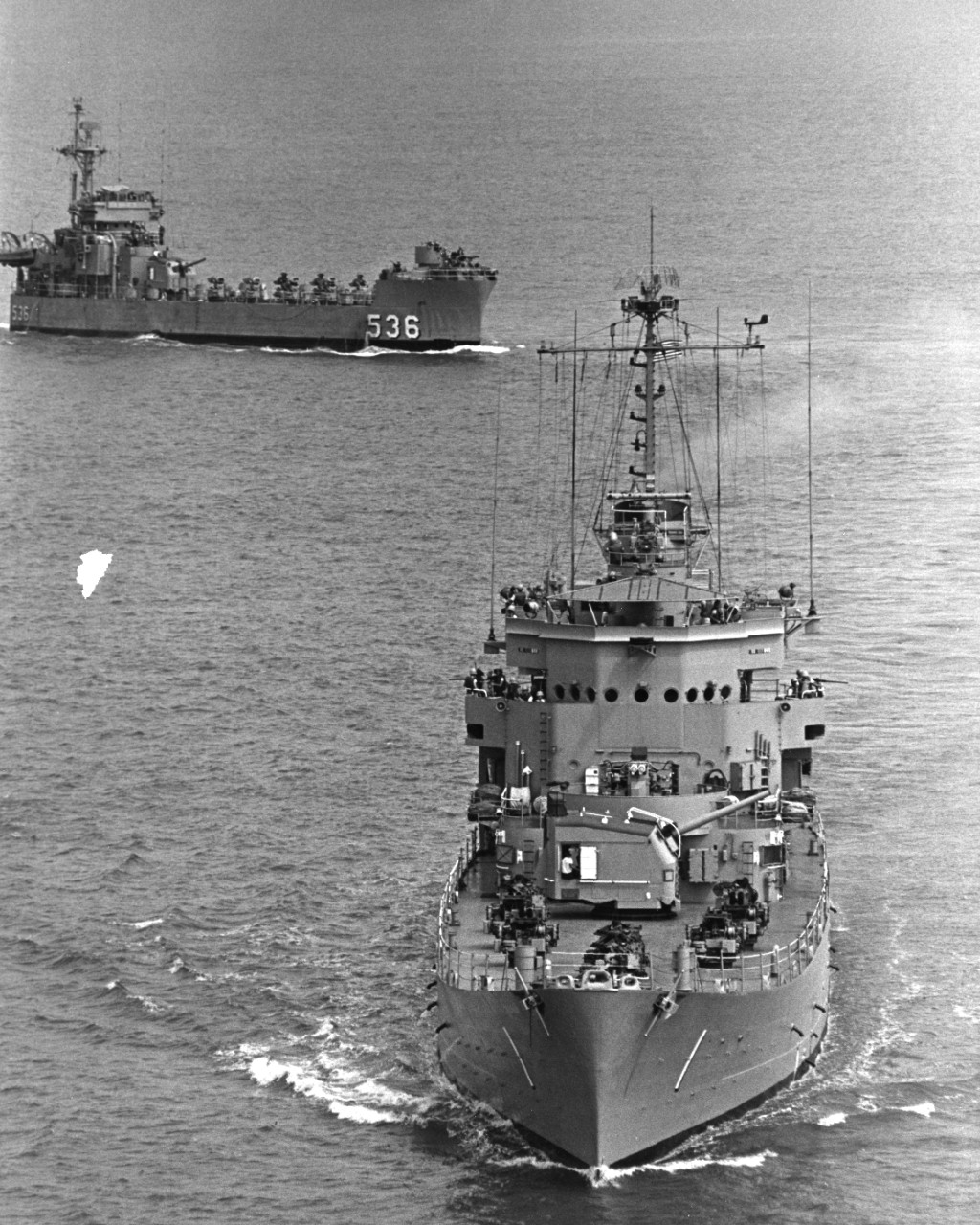 USS Carronade (IFS-1) steams off the coast of Danang, South Vietnam. USS White River (LSMR-536) steams in the background. Both are rocket firing ships.