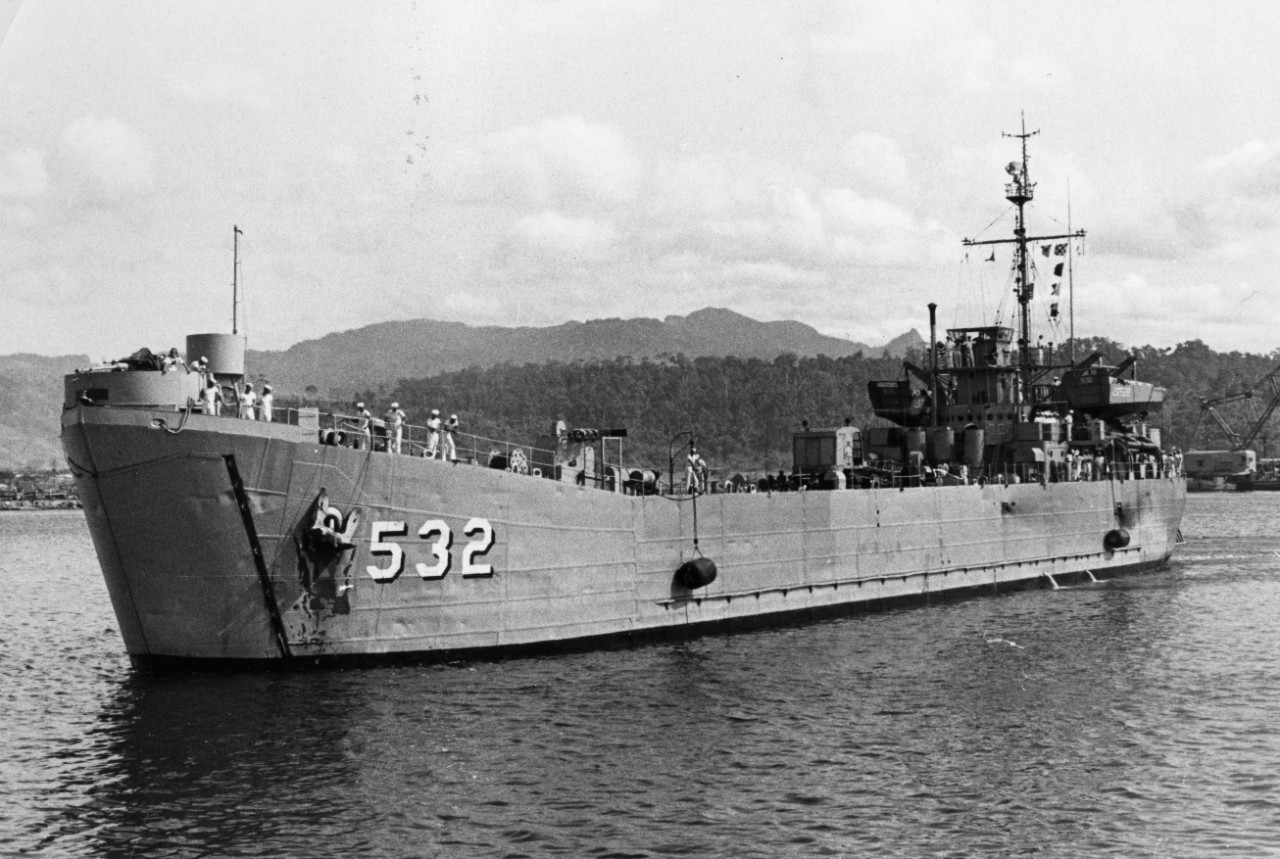 Tank landing ship USS Chase County (LST-532) steams into Subic Bay with 29 rescued Japanese fisherman on board.