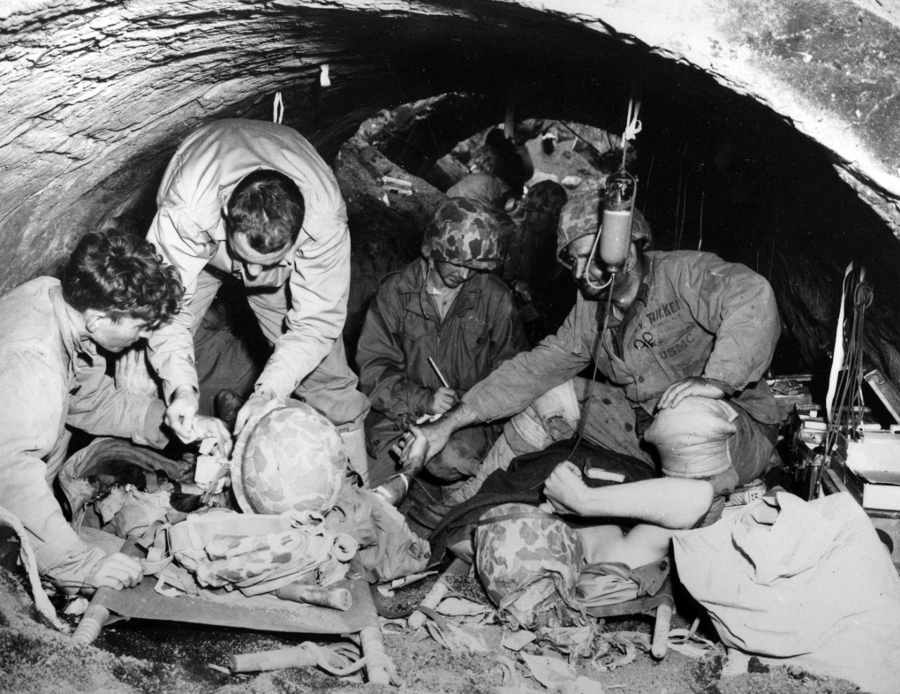 <p>Wounded Marines take cover in a concrete Japanese shelter on Iwo Jima. Although the structure suffered a direct artillery hit, the portions still standing later saw use as an aid station.</p>
