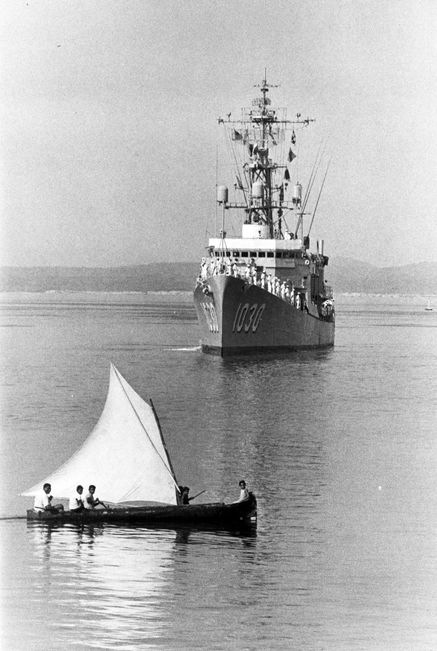 An Ecuadorian sailboat crosses the bow of the destroyer escort USS Joseph K. Taussig (DE-1030) enteri8ng port Guayaquil, Ecuador, August 19, 1969. 