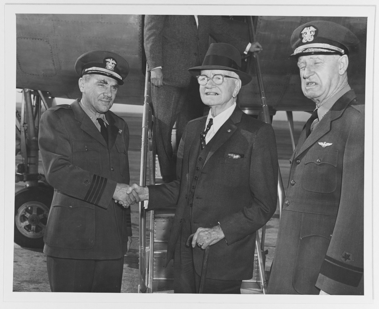 Captain James H. Mills, Jr., Fleet Admiral William F. Halsey, USN, and Rear Admiral R. F. Hickey, USN