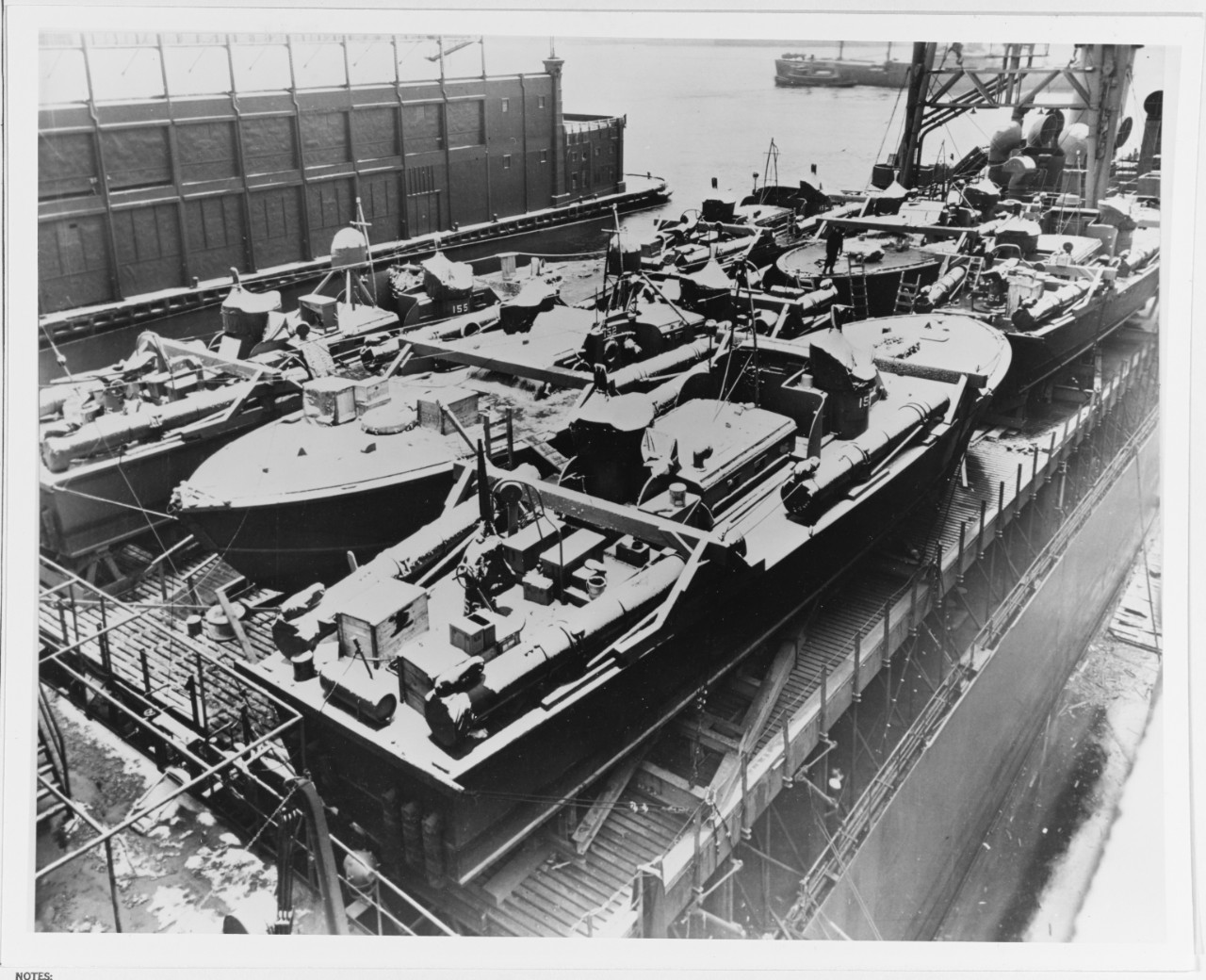 A light snowfall whitens boats of Squadron 9, loaded three abreast on SS White Plains in New York in December 1942 for shipment to Panama. See Page 64 of "At Close Quarters."