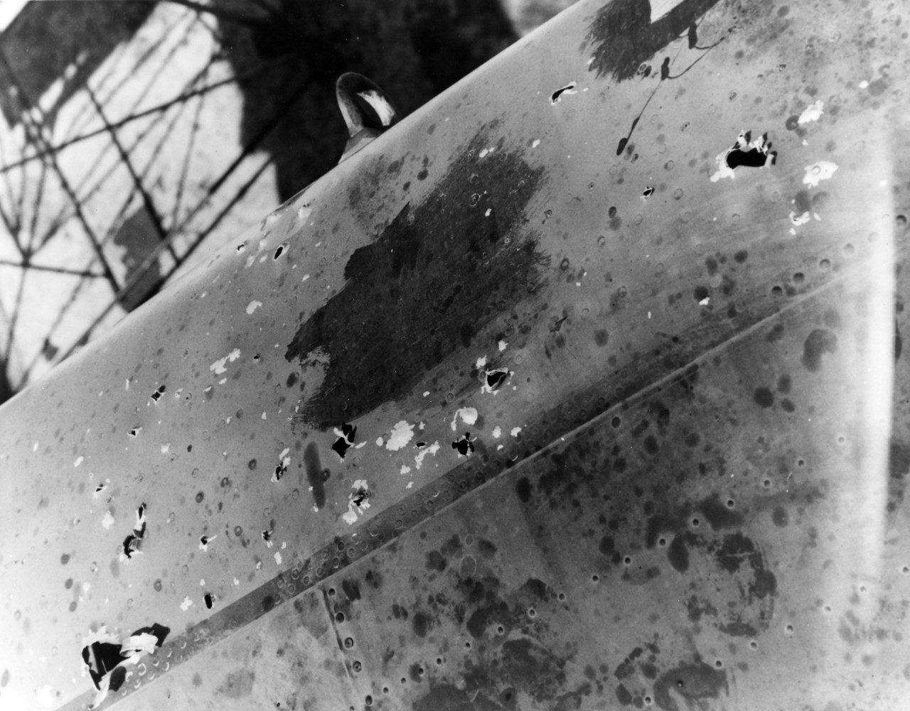 Anti-aircraft gunfire damage to starboard wing of a PBM "Mariner" aircraft