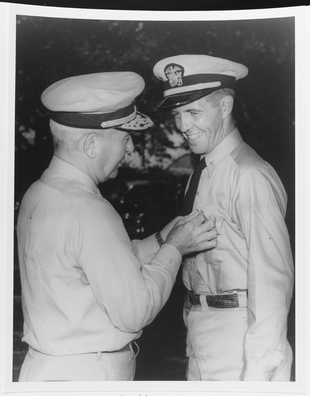 Rear Admiral James L. Kauffman, presents his son, Lieutenant Commander Draper L. Kauffman,