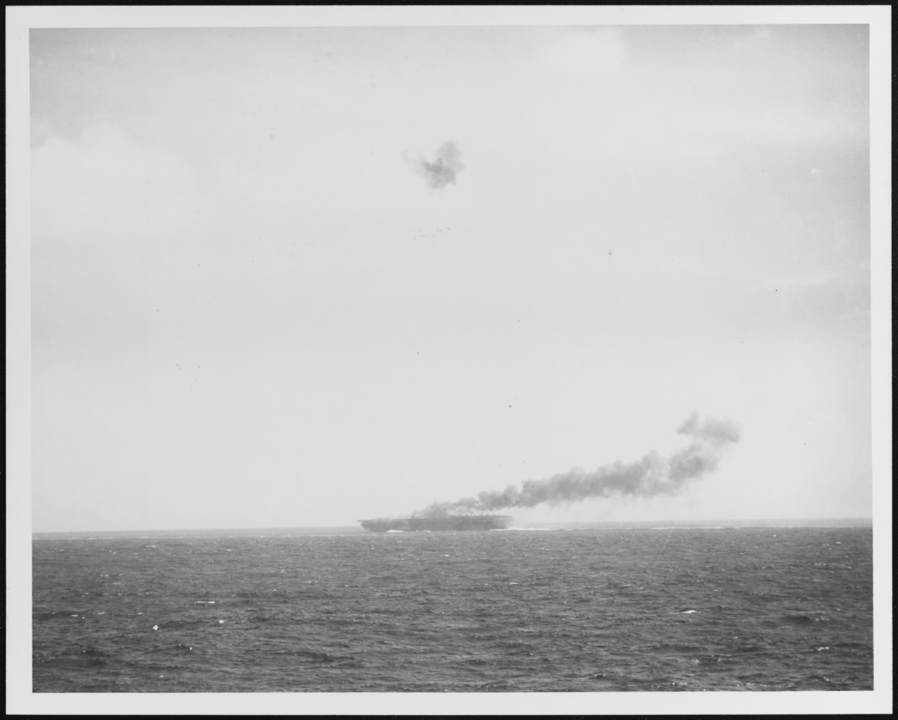 Burning carrier, the result of a Japanese Kamikaze attack.