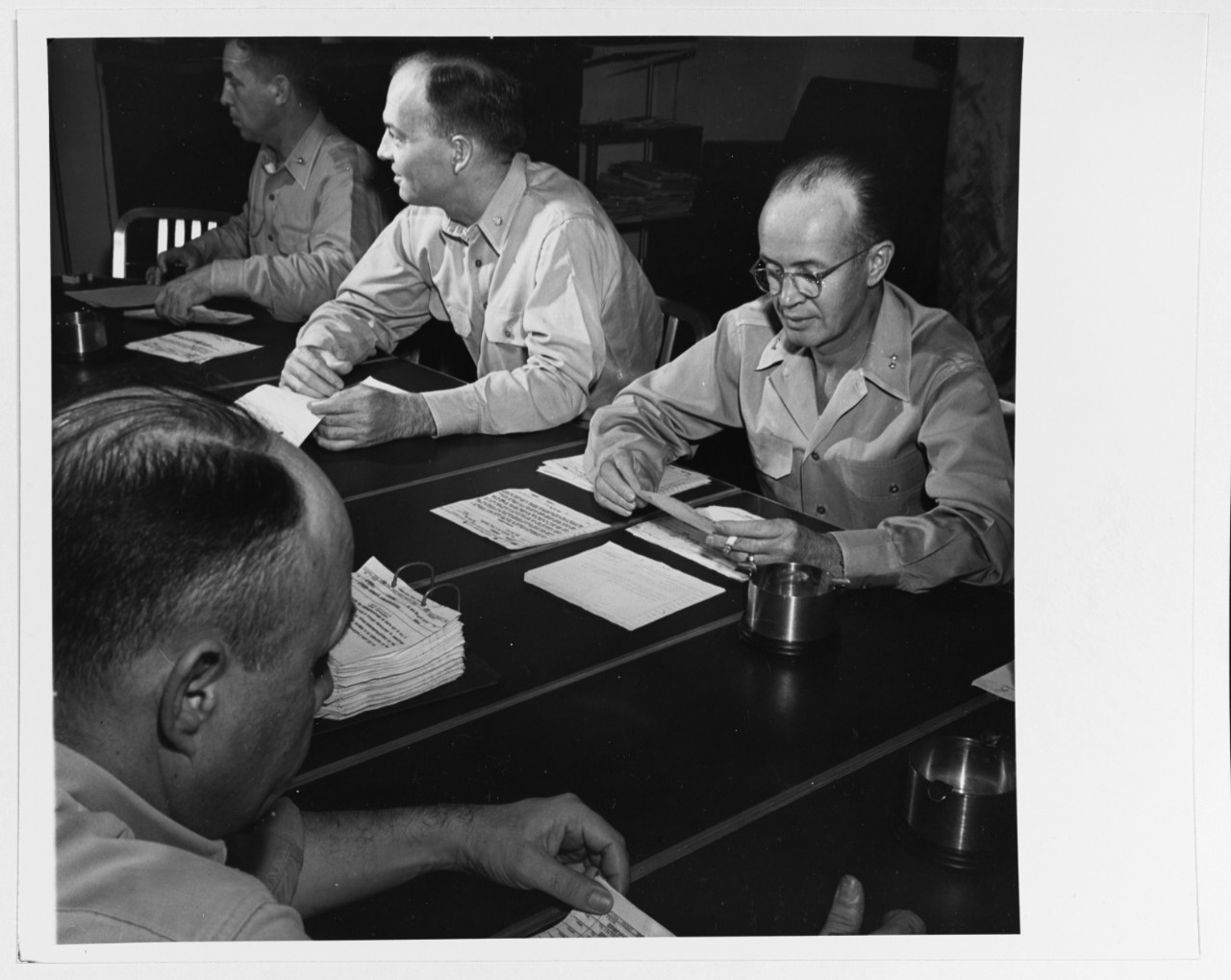 Staff of Admiral W.F. Halsey, Commander Third Fleet, in conference aboard USS NEW JERSEY (BB-62), December 1944.