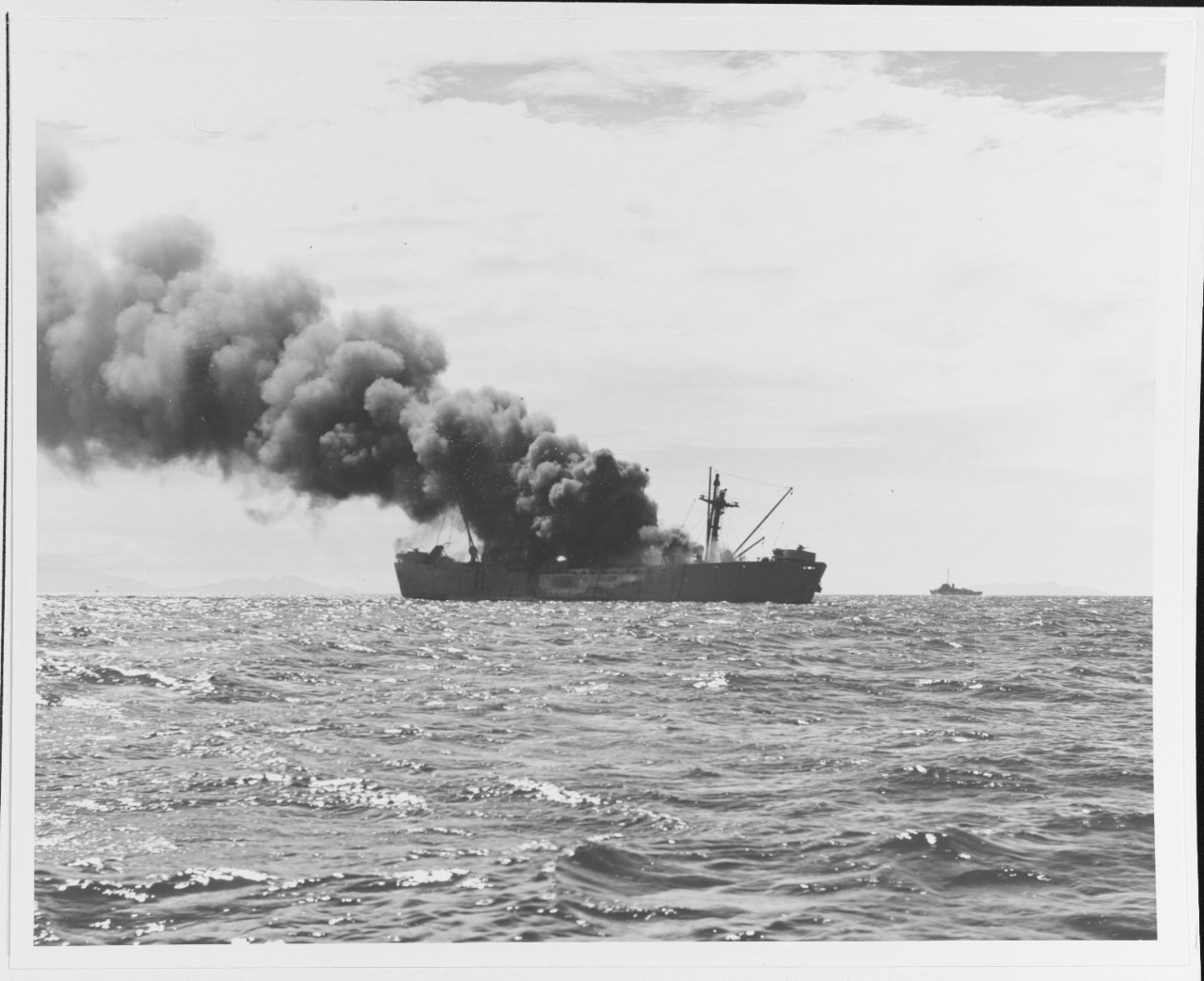 A "Liberty" ship burning off Guadalcanal