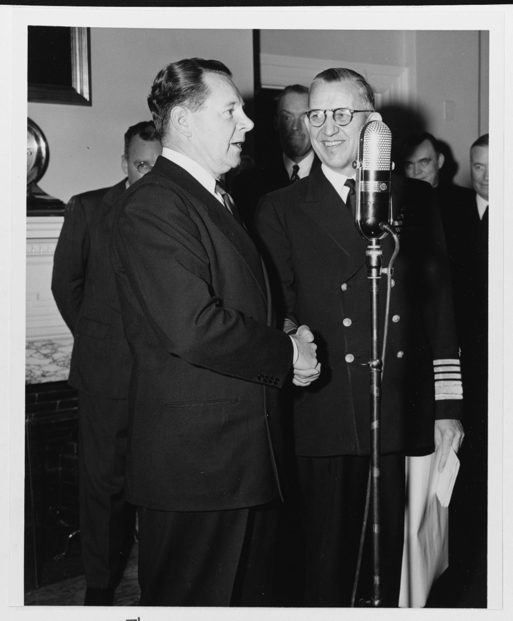 Secretary of the Navy John L. Sullivan congratulates Admiral Louis E. Denfeld, USN