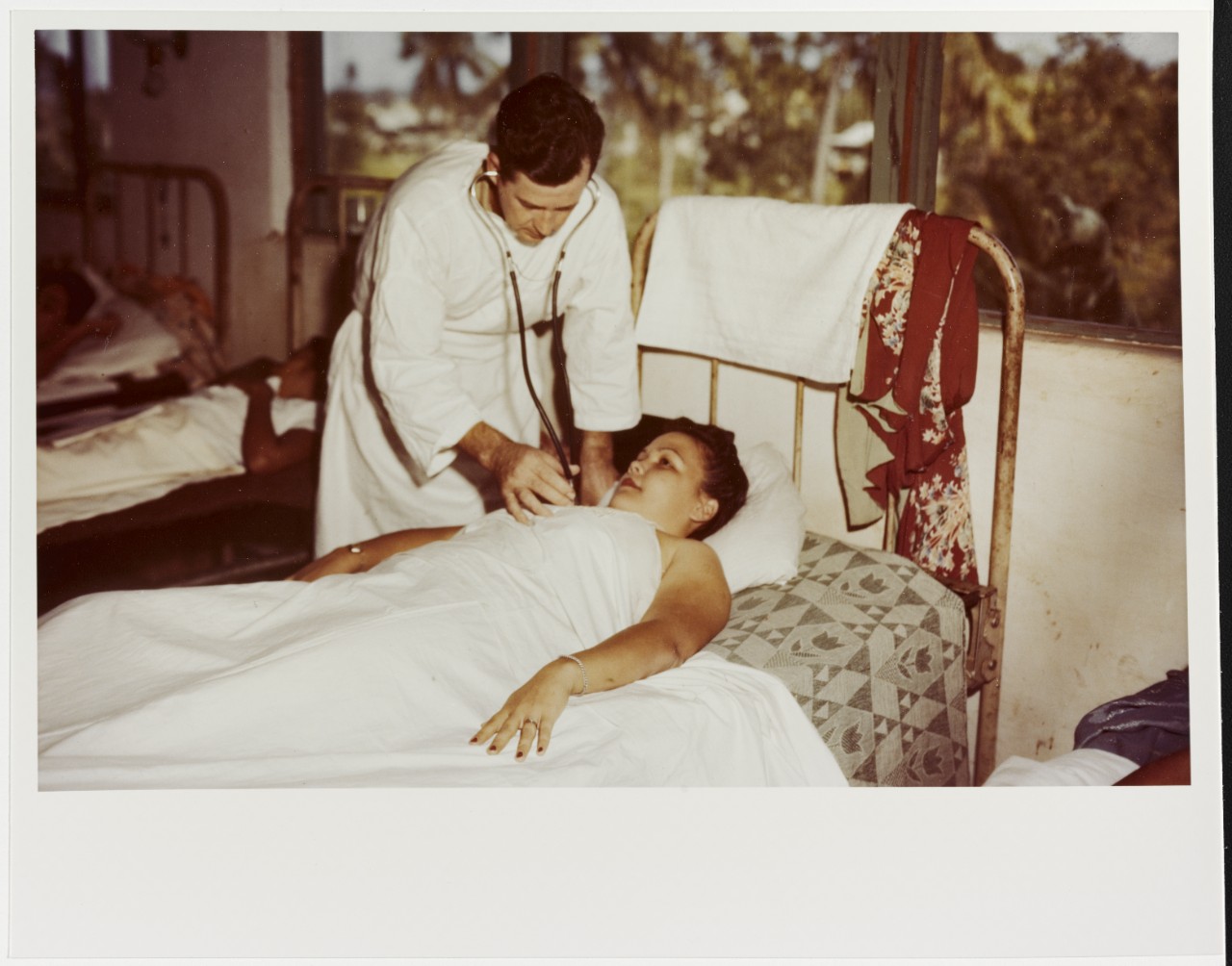Lieutenant Edgar L. Aaberg, USNR (MC) examines a woman in hospital at Agana, Guam, in 1944-1945