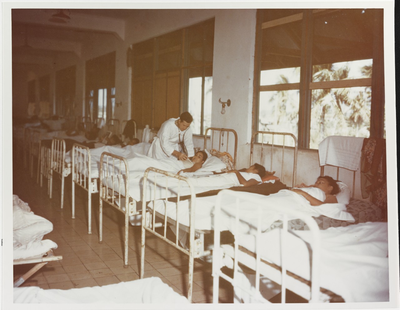 Lieutenant Edgar L. Aaberg, USNR (MC) making the rounds in hospital at Agana, Guam, in 1944-1945